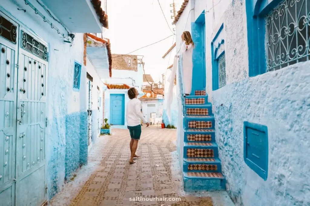 Blue painted alley in Chefchaouen Morocco with traditional buildings